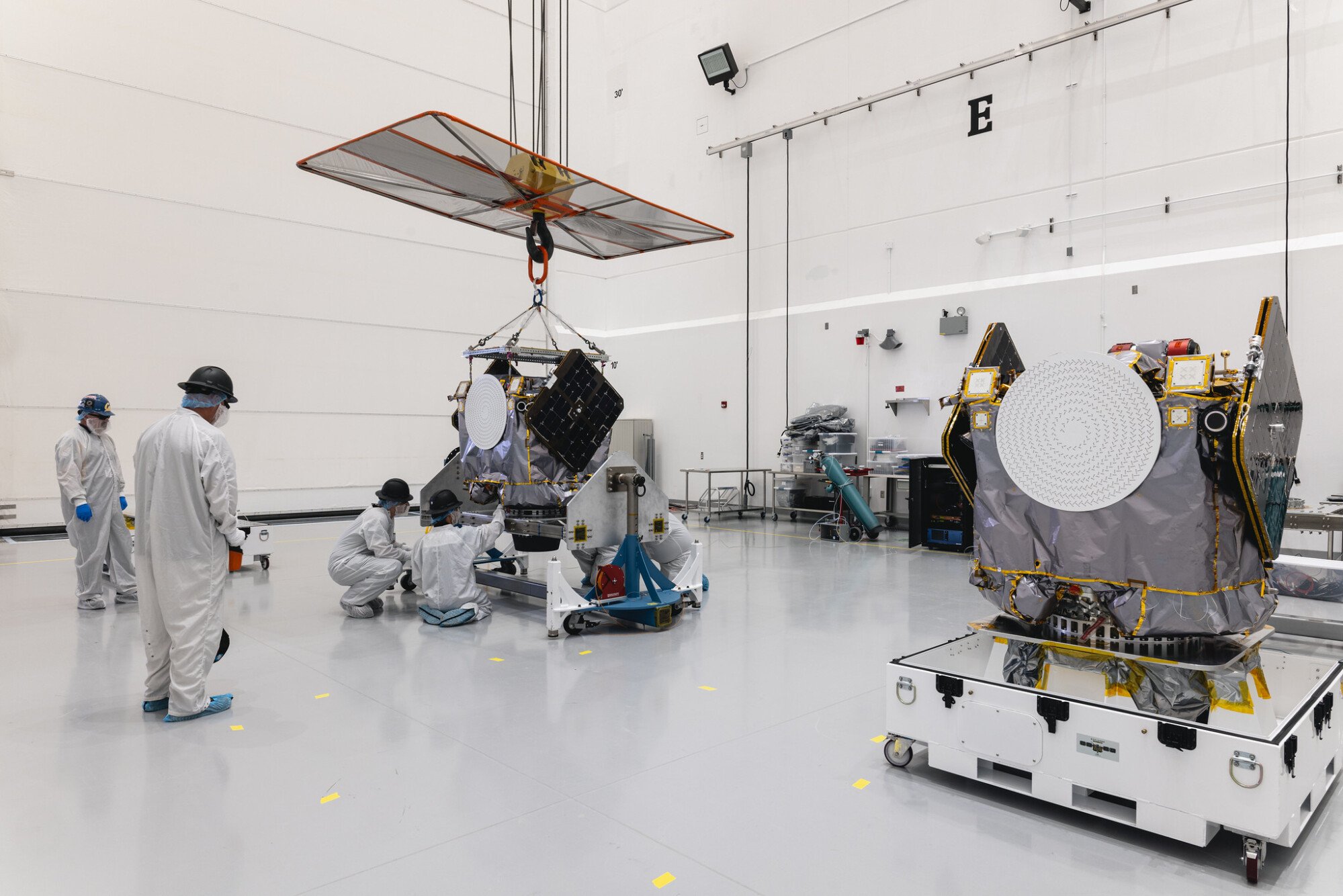 Engineers and technicians preparing Blue and Gold spacecraft for launch