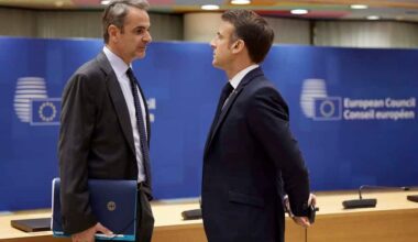 (L) Greek Prime Minister Kyriakos Mitsotakis talks to President of France Emanuel Macron