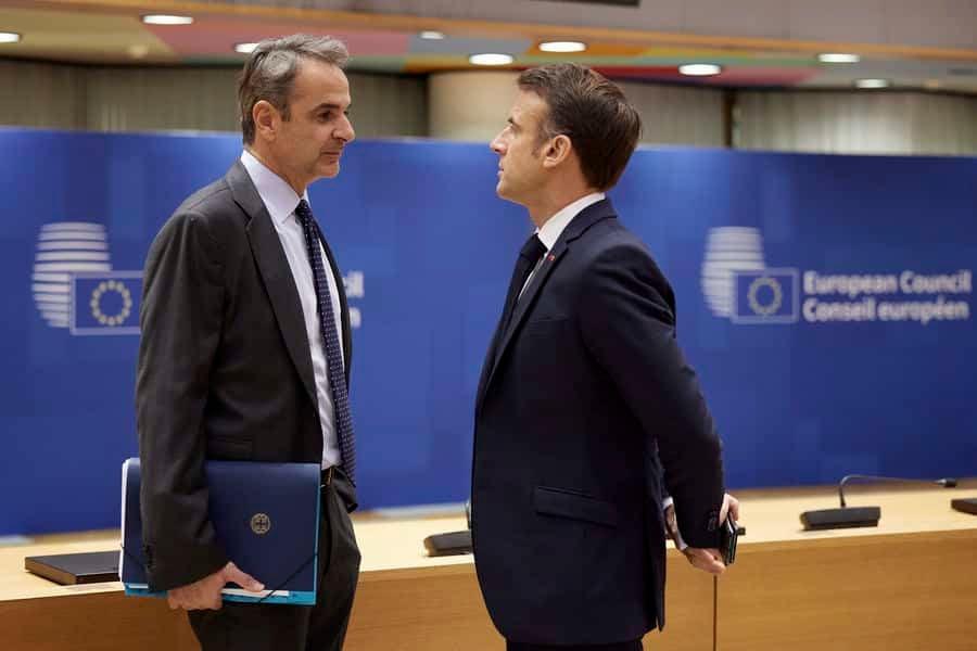 (L) Greek Prime Minister Kyriakos Mitsotakis talks to President of France Emanuel Macron