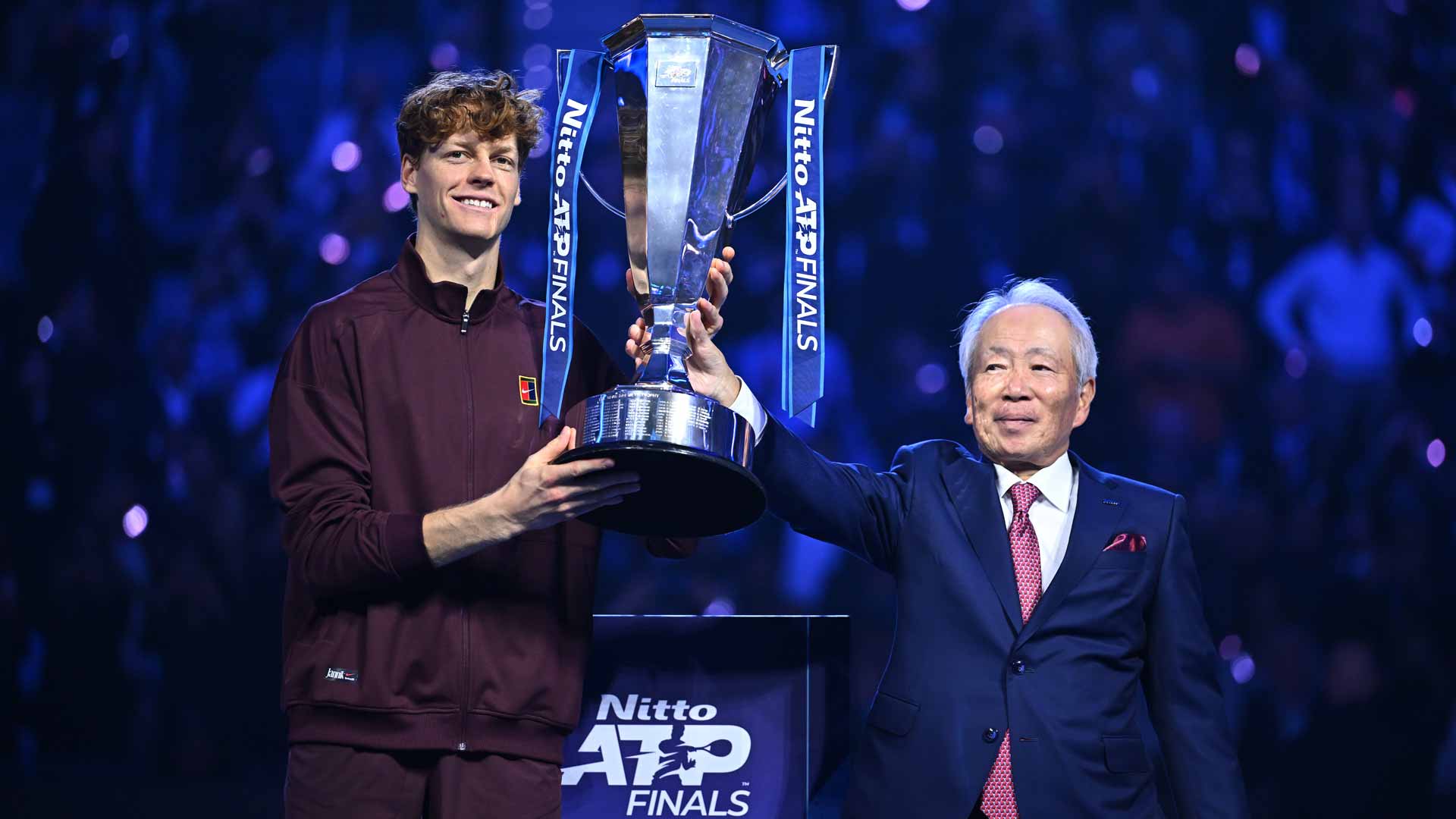 Nitto President and CEO Hideo Takasaki presenting the Nitto ATP Finals trophy to 2025 champion Jannik Sinner.