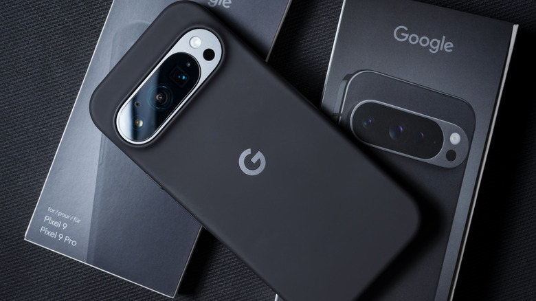 Google Pixel 9 Pro with a case on two Pixel boxes