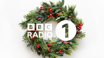 BBC Radio 1 Christmas graphic featuring the BBC R1 logo in white over the top of a Christmas wreath covered in red berries. 