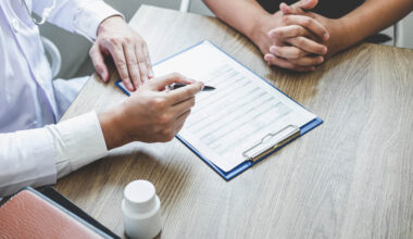 Doctor having conversation with patient while discussing explaining symptoms or counsel diagnosis health and consult treatment of disease, healthcare and assistance concept.