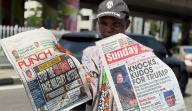 A vendor sells local newspapers in Lagos, AP Photo/Sunday Alamba