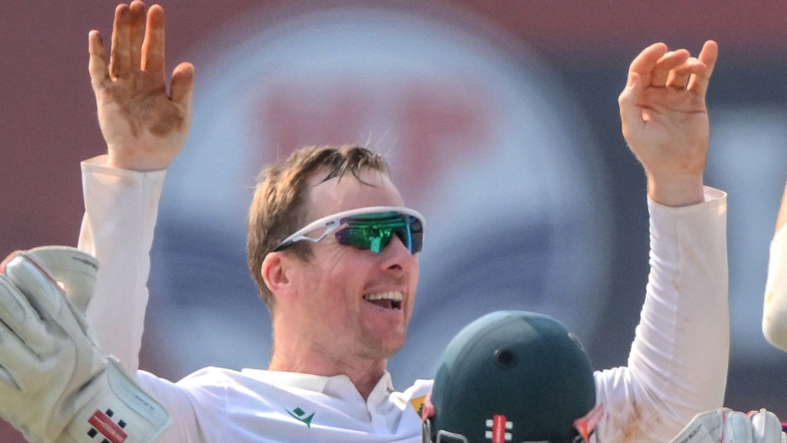 South Africa's Simon Harmer (L) celebrates with teammates after taking the wicket of India's Yashasvi Jaiswal during the third day of the second Test cricket match between India and South Africa at the Barsapara Cricket Stadium in Guwahati on November 24, 2025. (Photo by Biju BORO / AFP) / -- IMAGE RESTRICTED TO EDITORIAL USE - STRICTLY NO COMMERCIAL USE --
