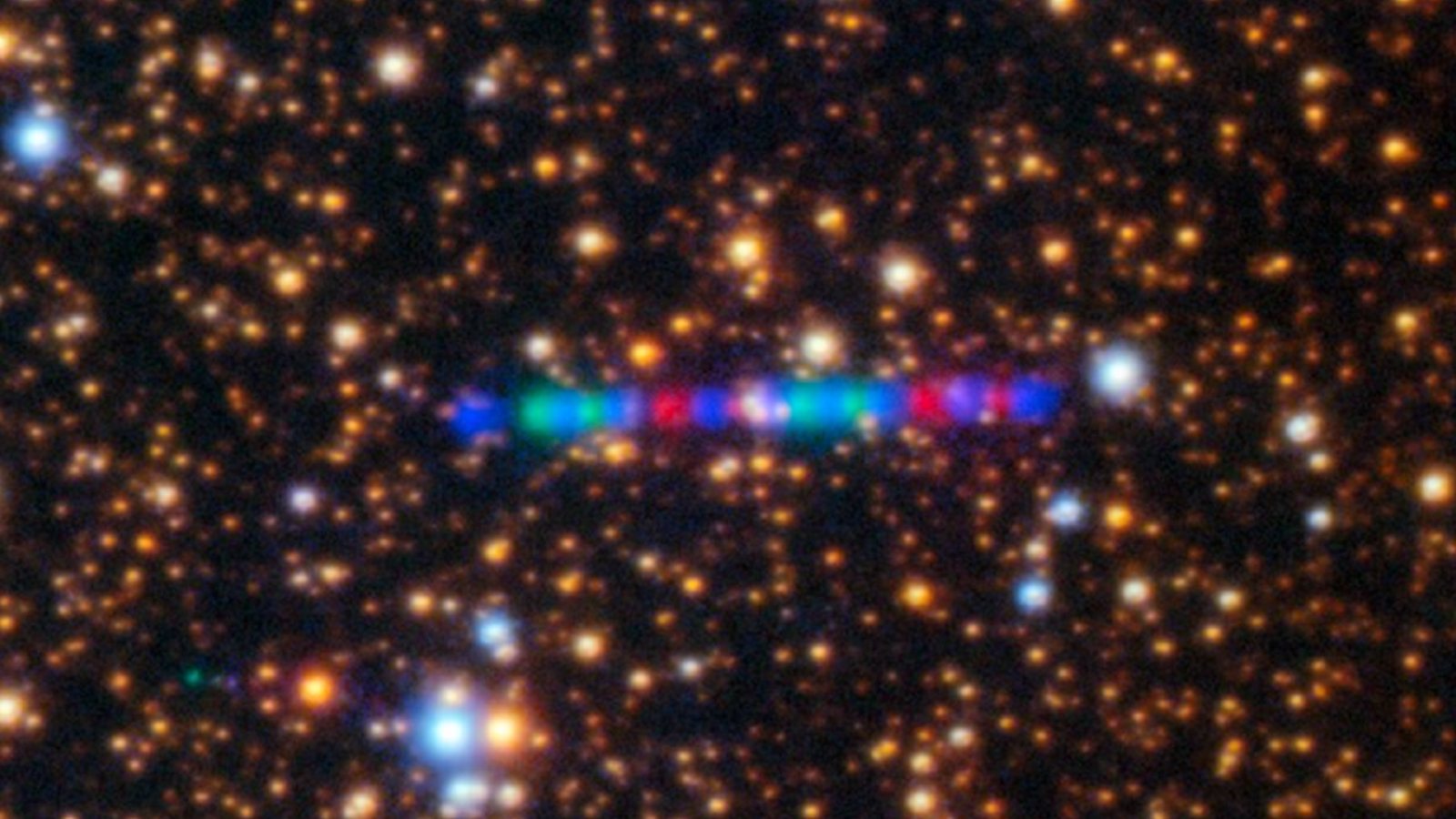 Photograph of a string of blue, red and green lights against a starry background