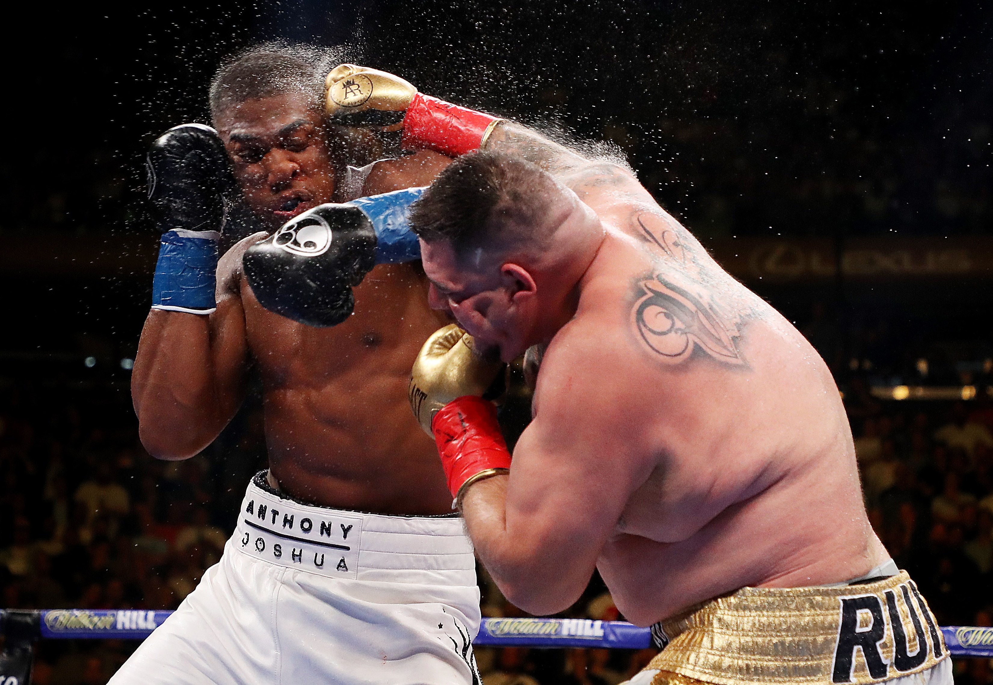 Andy Ruiz Jr. punching Anthony Joshua in the face during a boxing match at Madison Square Garden.