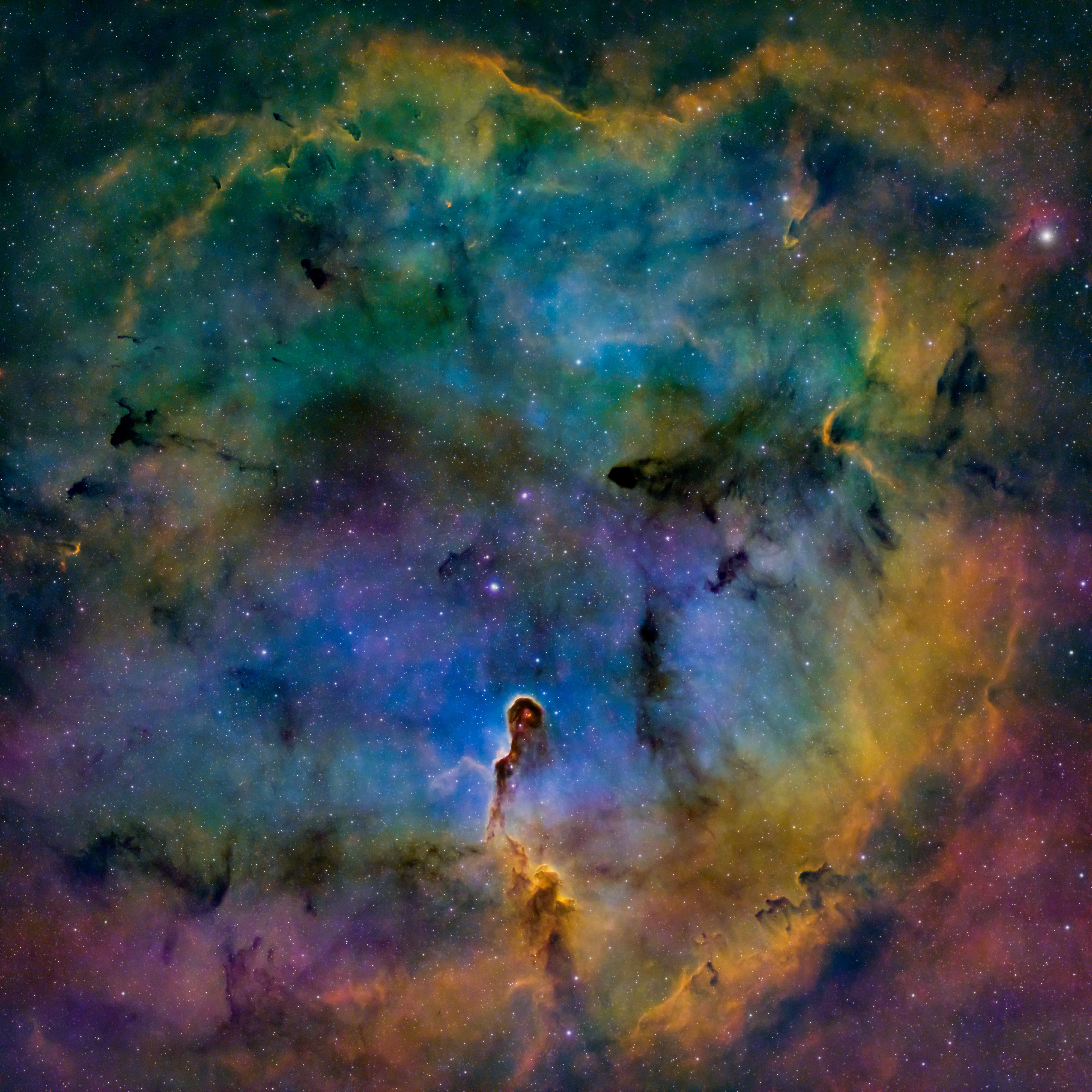 A cosmic elephants trunk glowing in technicolour space