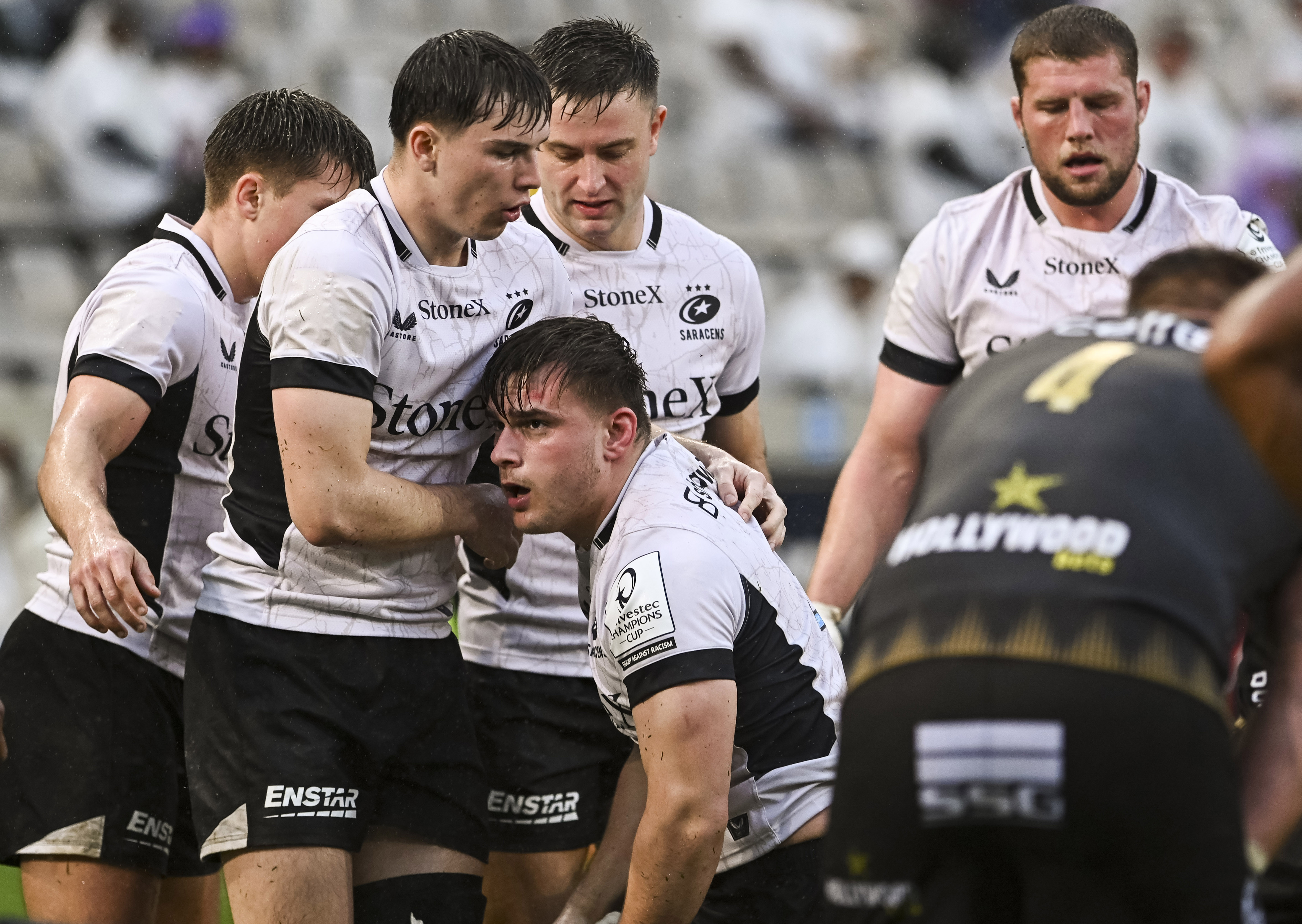 Saracens player Theo Dan, supported by his teammates, after scoring a try against Hollywoodbets Sharks.