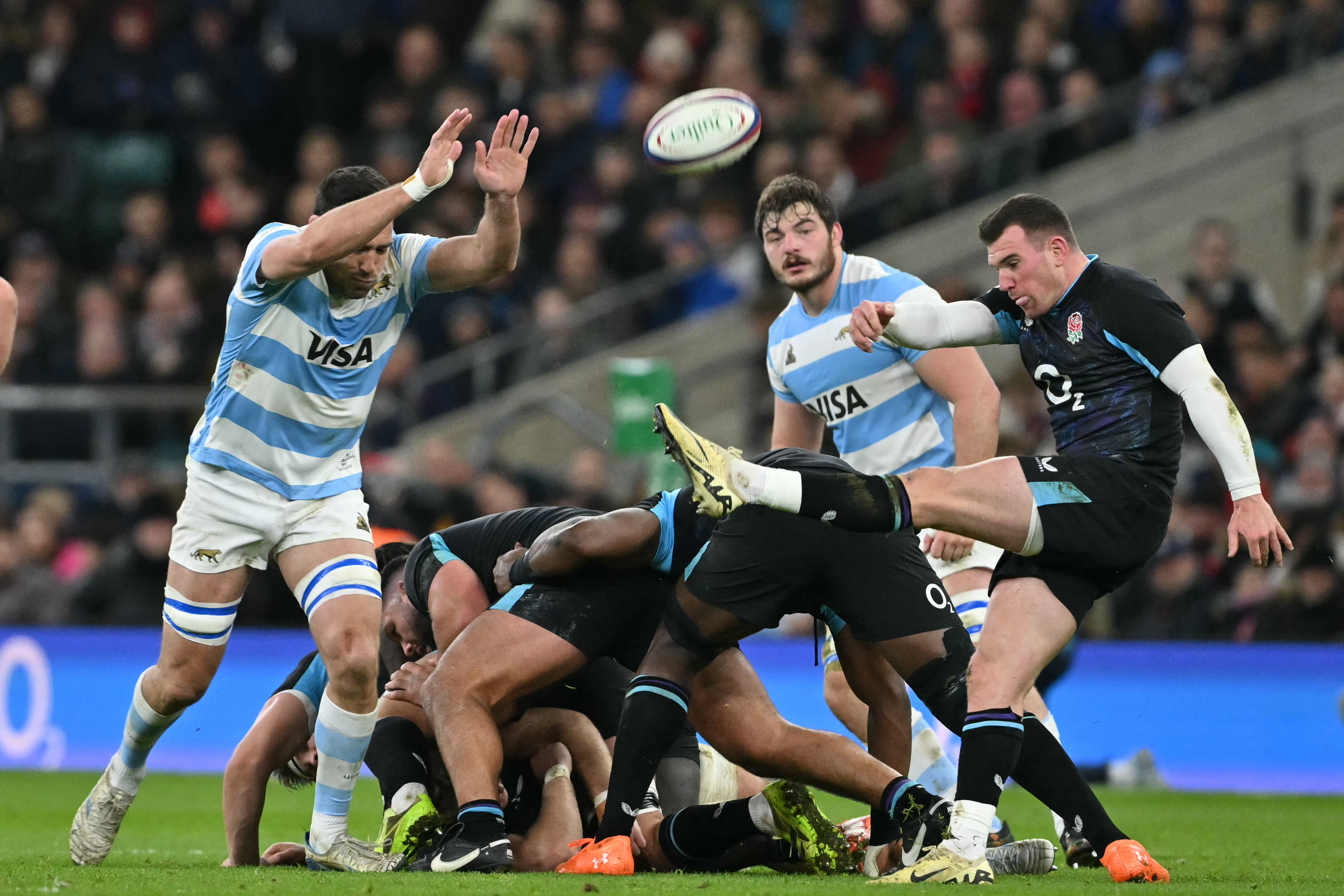 Argentina's lock Guido Petti attempts to charge down a kick from England's scrum-half Ben Spencer during a rugby union match.