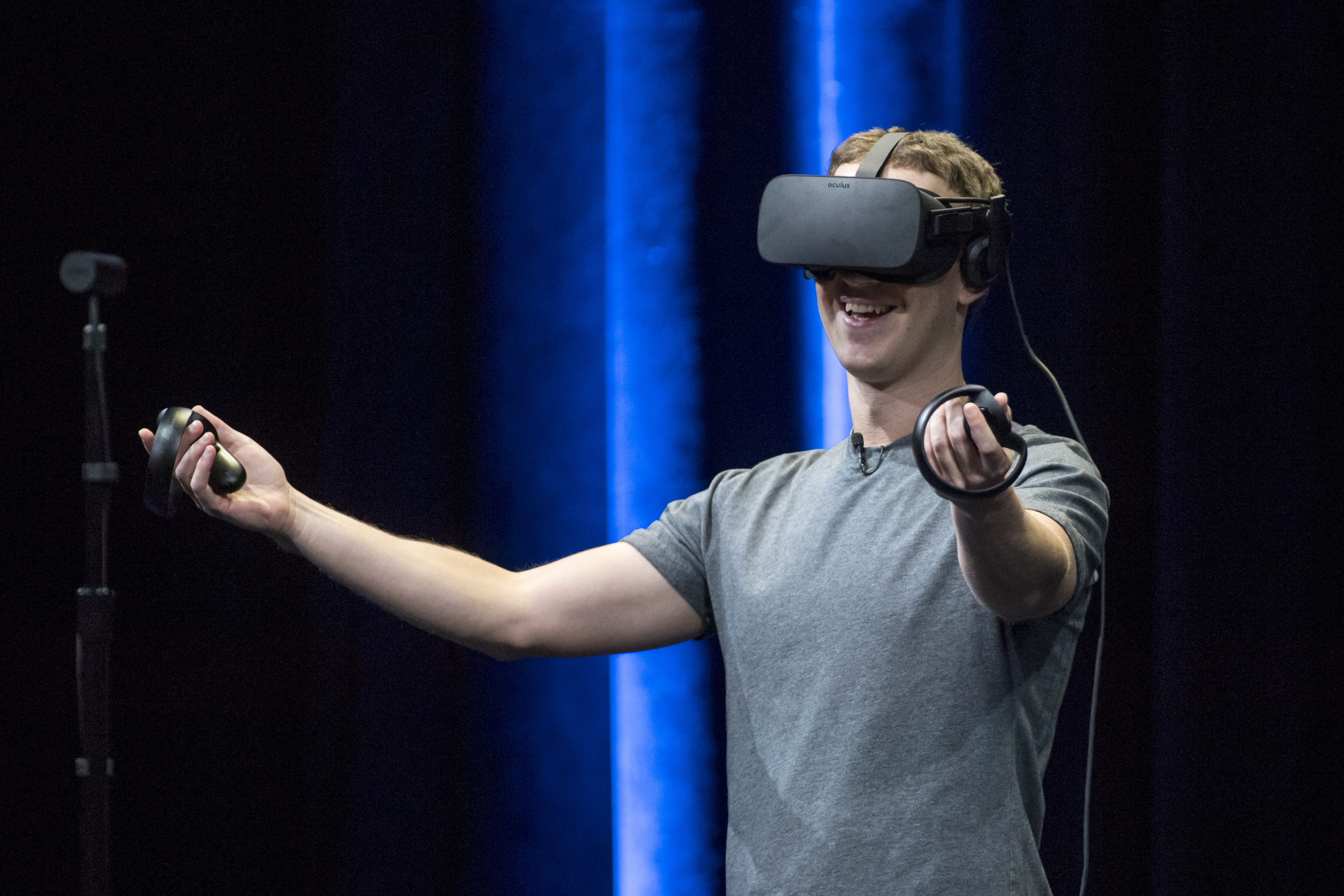 Mark Zuckerberg demonstrates an Oculus Rift virtual reality headset and Oculus Touch controllers.