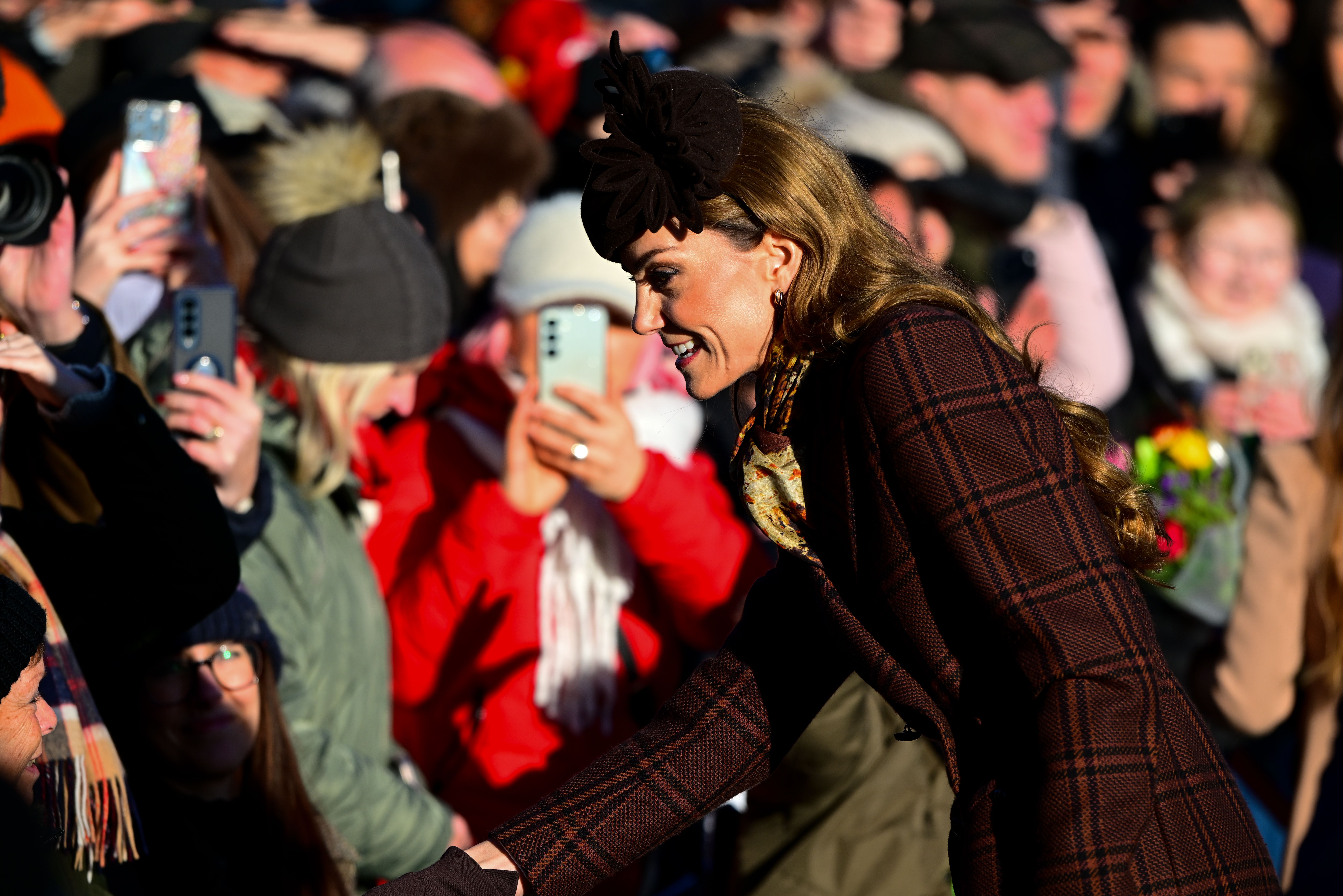 Catherine, Princess of Wales, smiling and greeting people in a crowd.