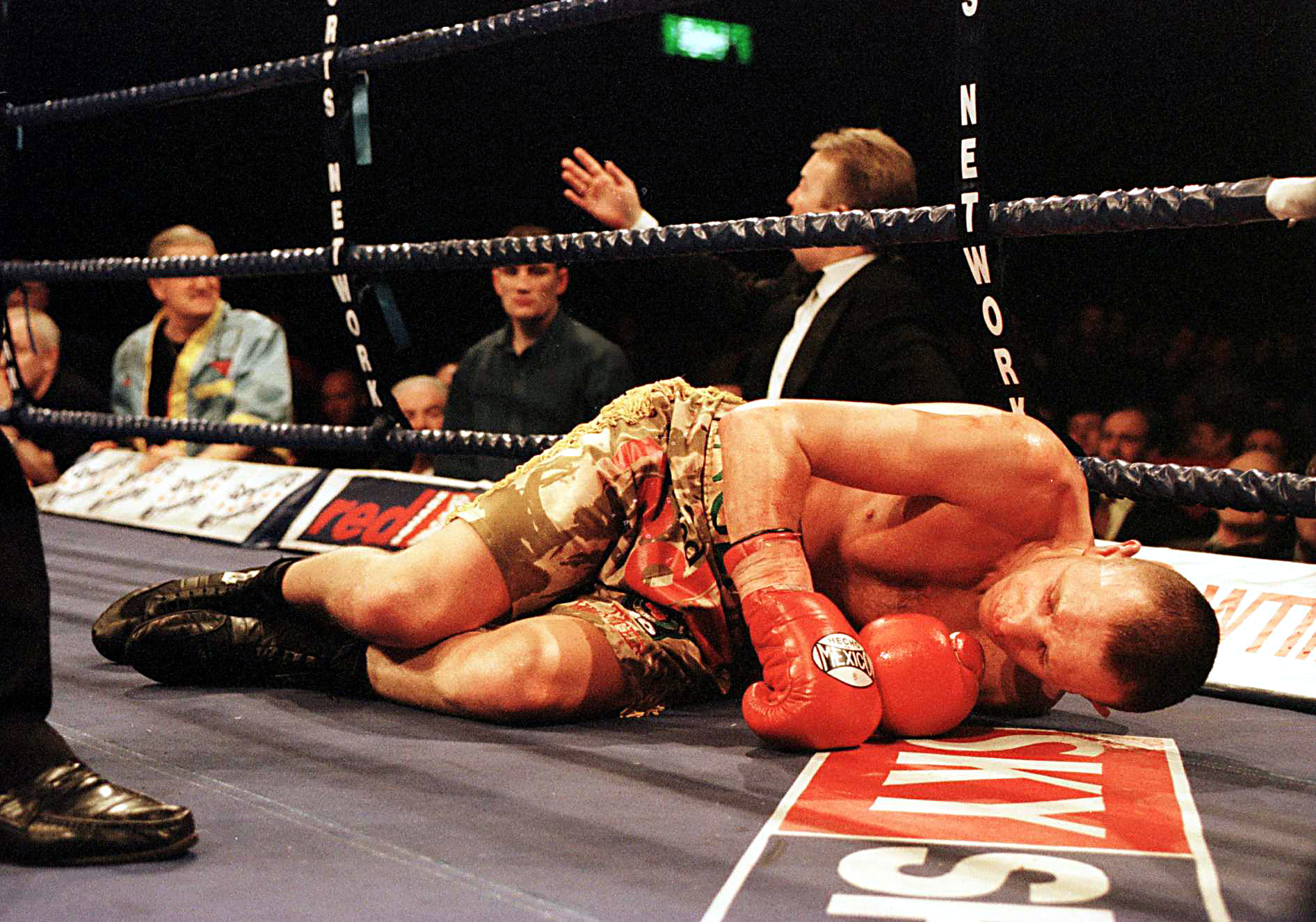 Boxer Paul Ingle knocked out on the mat with promoter Frank Warren calling for medics in the background.