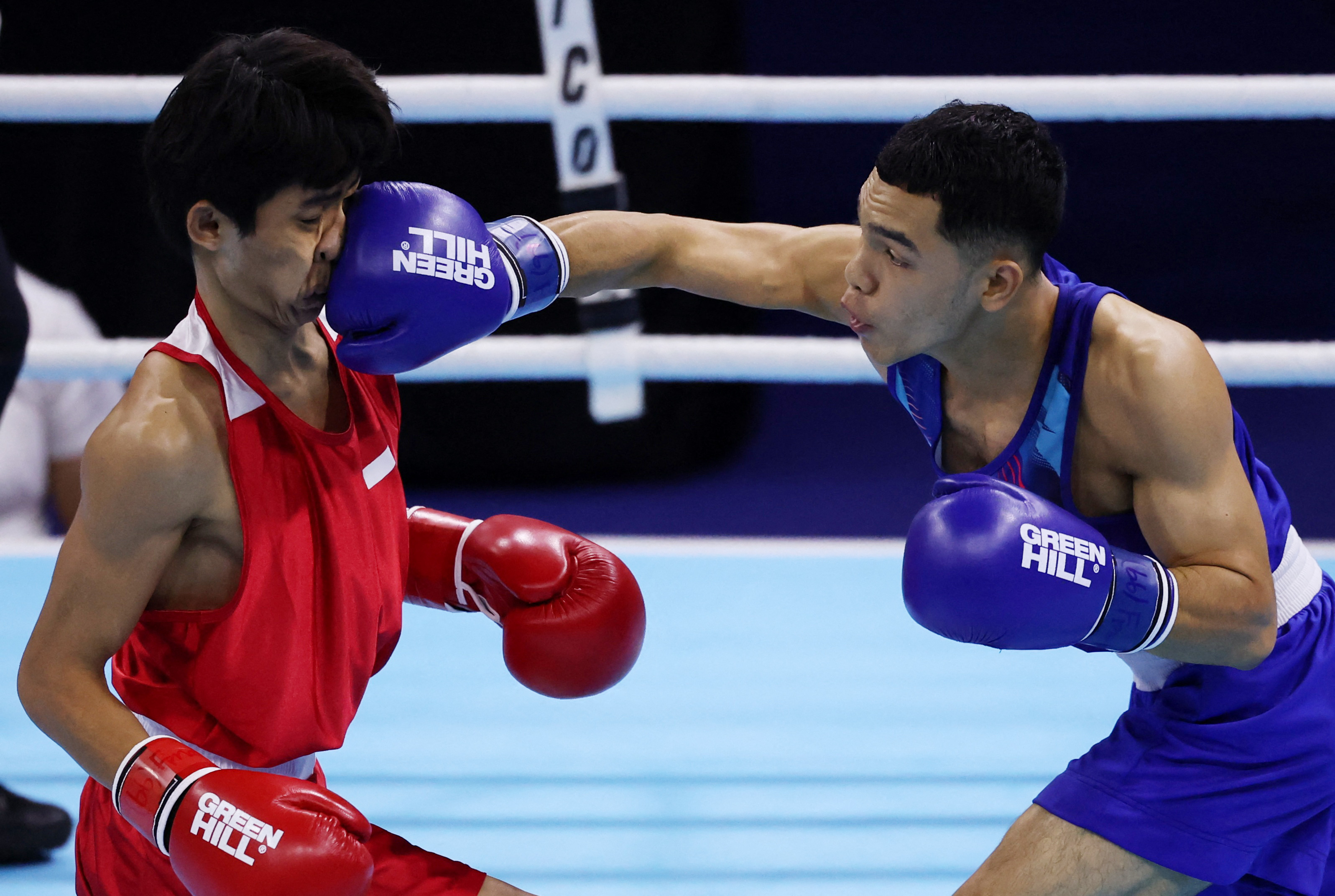 Thailand's Thitisan Panmot lands a punch on Indonesia's Vicky Tahumil Junior during the men's flyweight gold medal boxing match at the Southeast Asian Games.