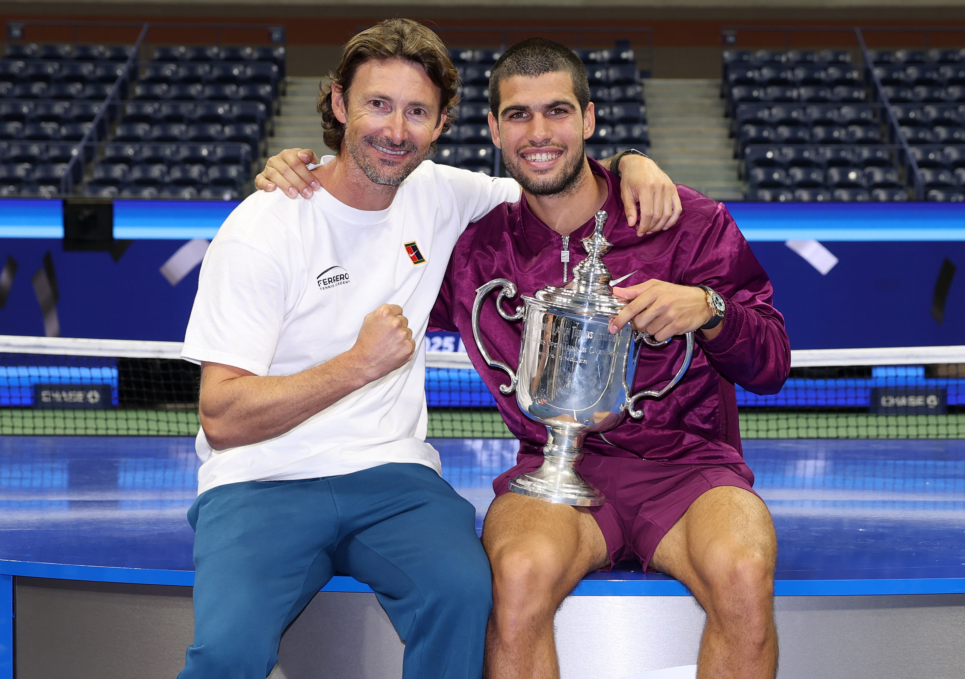Carlos Alcaraz and coach Juan Carlos Ferrero celebrating with the US Open trophy.