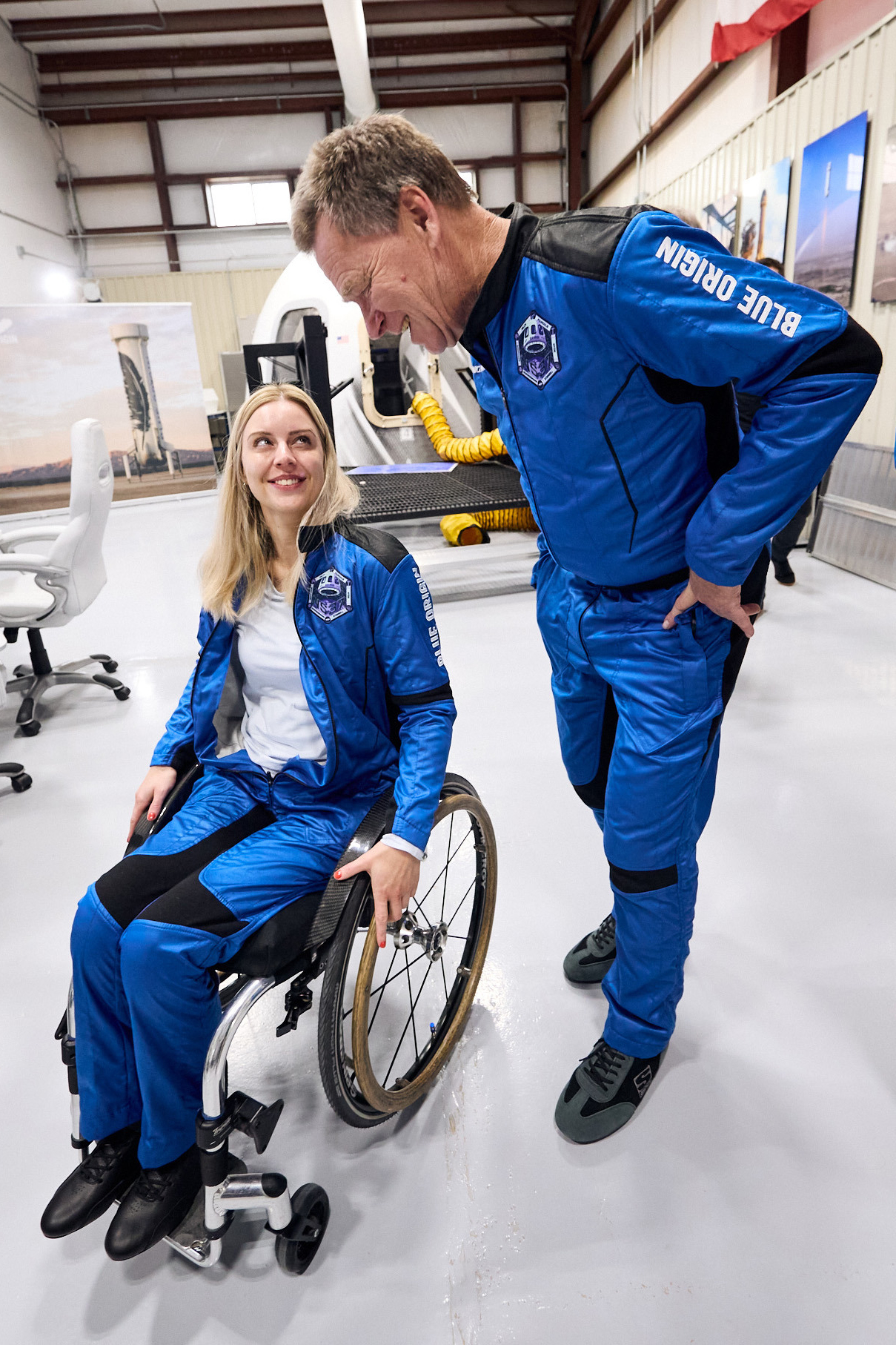 Michaela Benthaus, a German engineer and wheelchair user, talking to Hans Koenigsmann, a retired SpaceX executive, at Blue Origin’s rocket launch site.