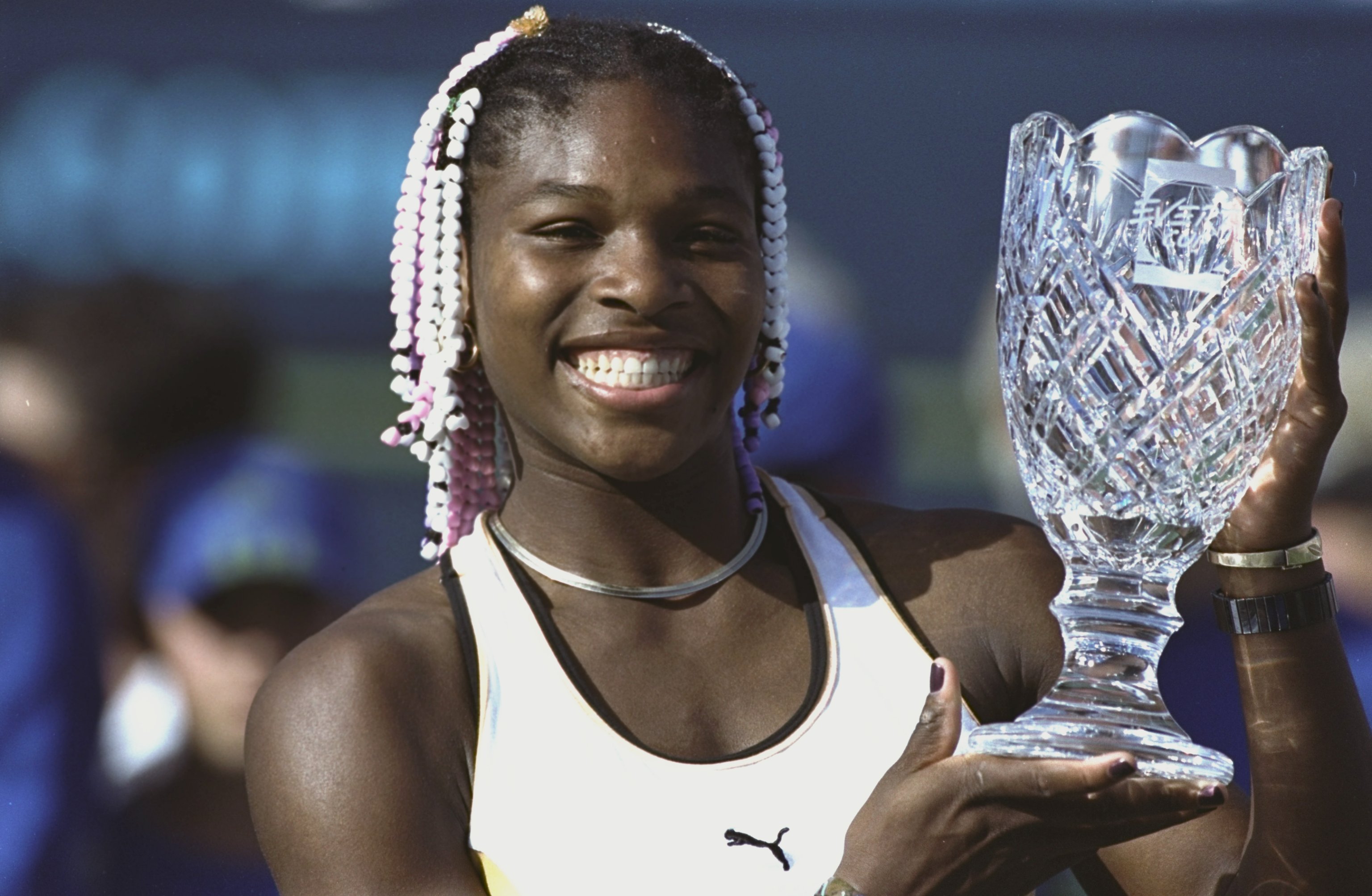 Serena Williams holding up her trophy after winning the Evert Cup.