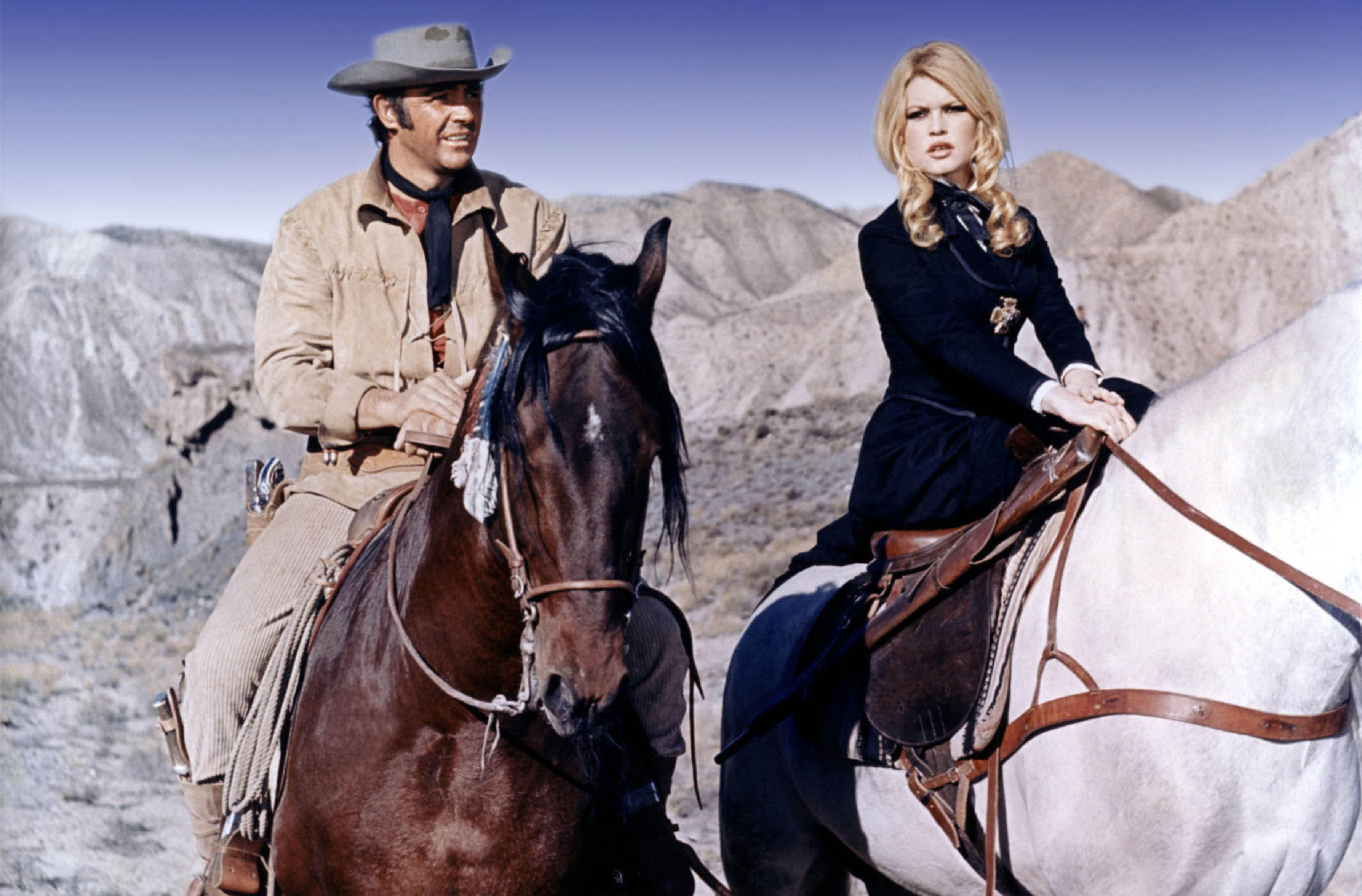 Sean Connery and Brigitte Bardot on horseback in a desert landscape in "Shalako" (1968).