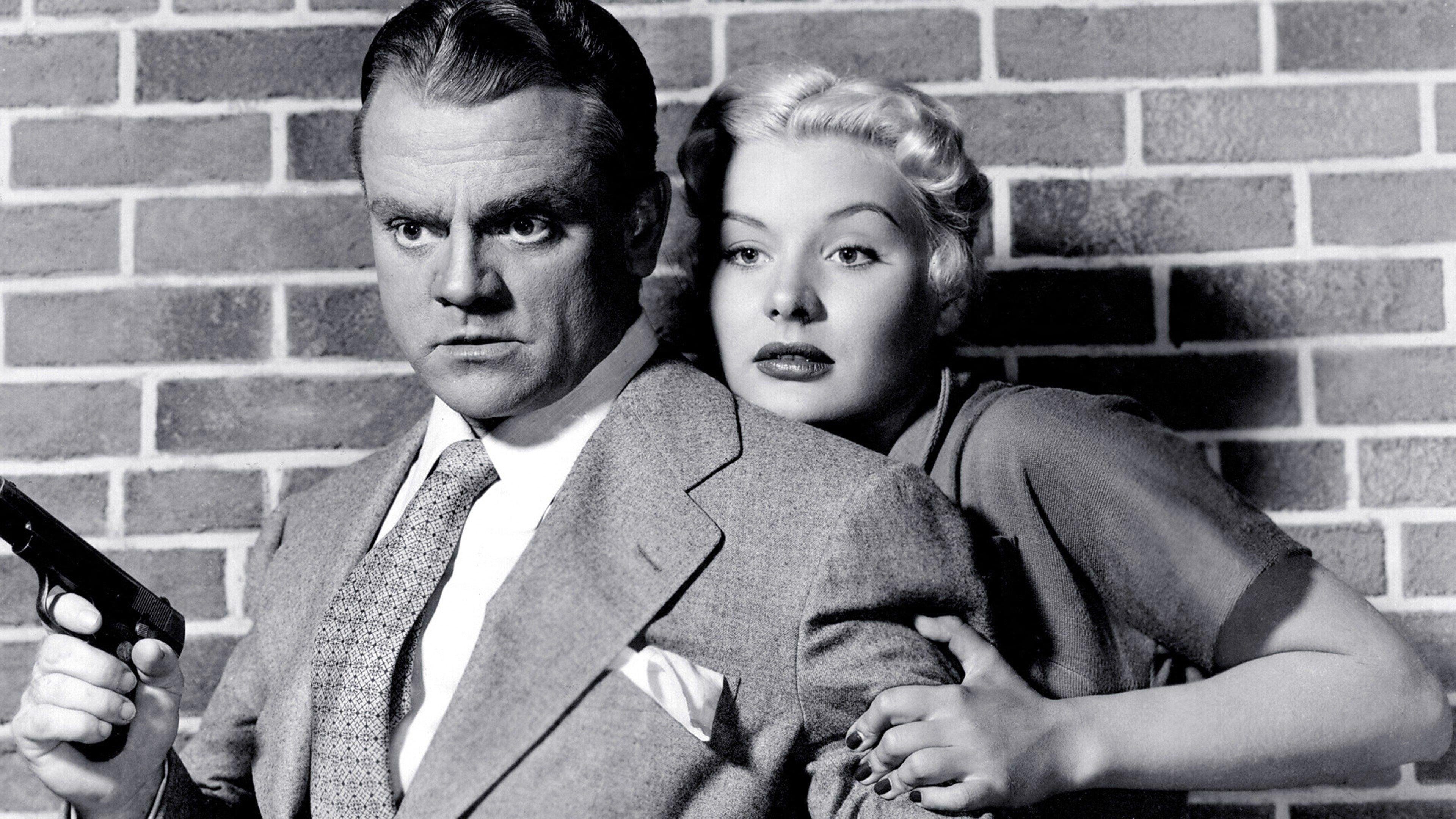 James Cagney holds a gun as Barbara Payton clings to him in "Kiss Tomorrow Goodbye."