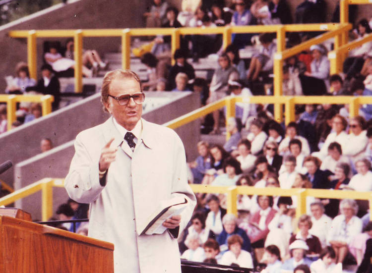American evangelist Billy Graham speaking at an outdoor event in Norwich, 1984.