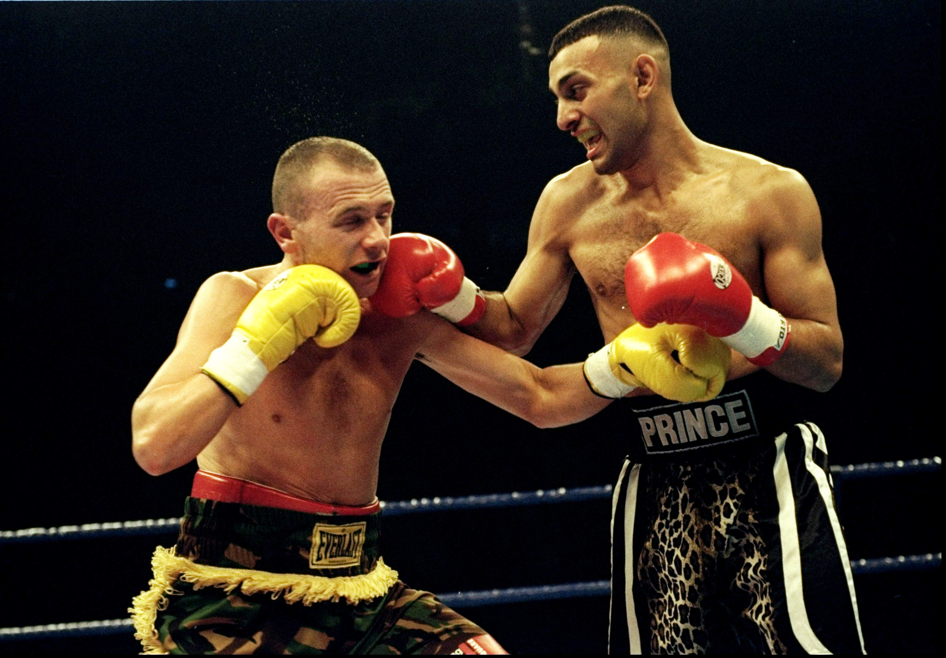 Prince Nassem Hamed delivers a right hook to Paul Ingle's chin during a boxing match.