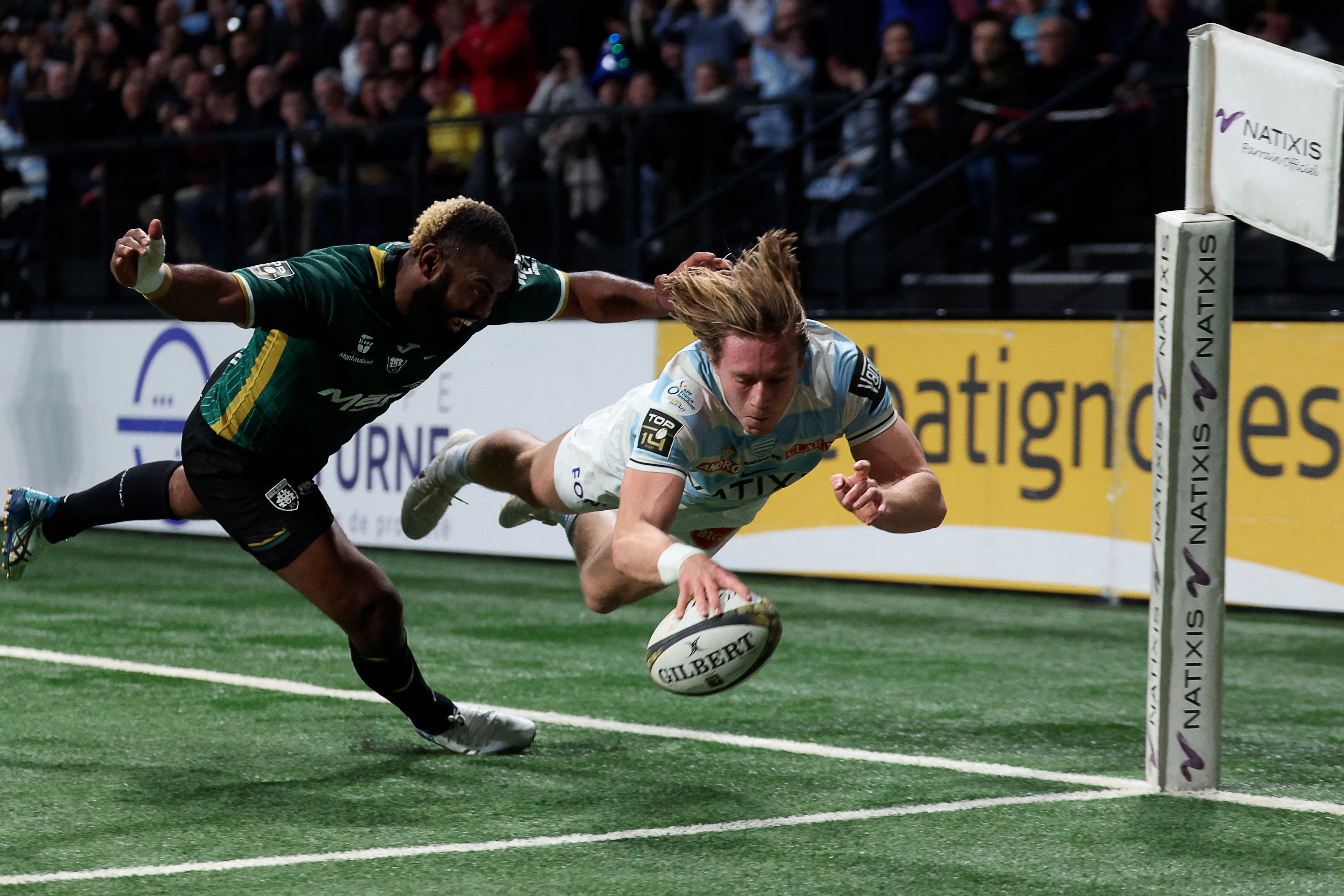 Racing 92 winger Wilfried Hulleu dives to score a try during a rugby union match against US Montauban.