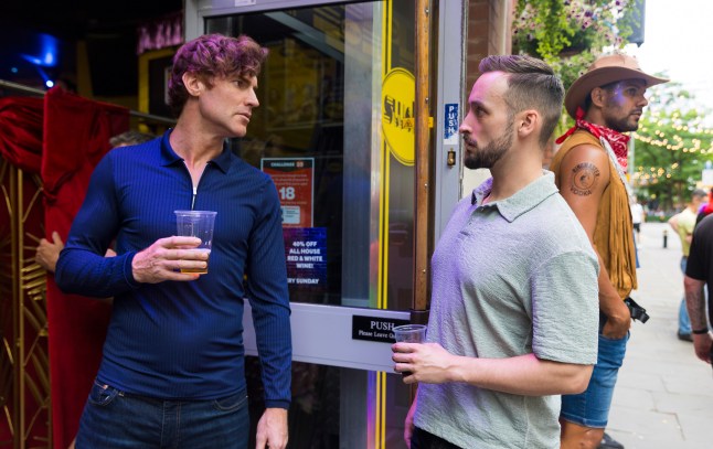 Theo and Owen talking in the doorway of a club in Corrie