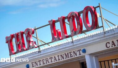 A sign on top of a building reading THE LIDO in red lettering