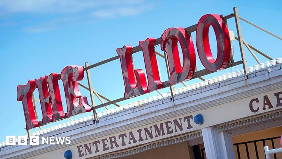 A sign on top of a building reading THE LIDO in red lettering