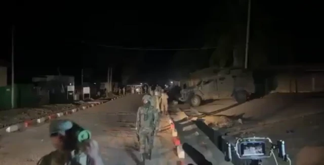 Soldiers walking down a dark road