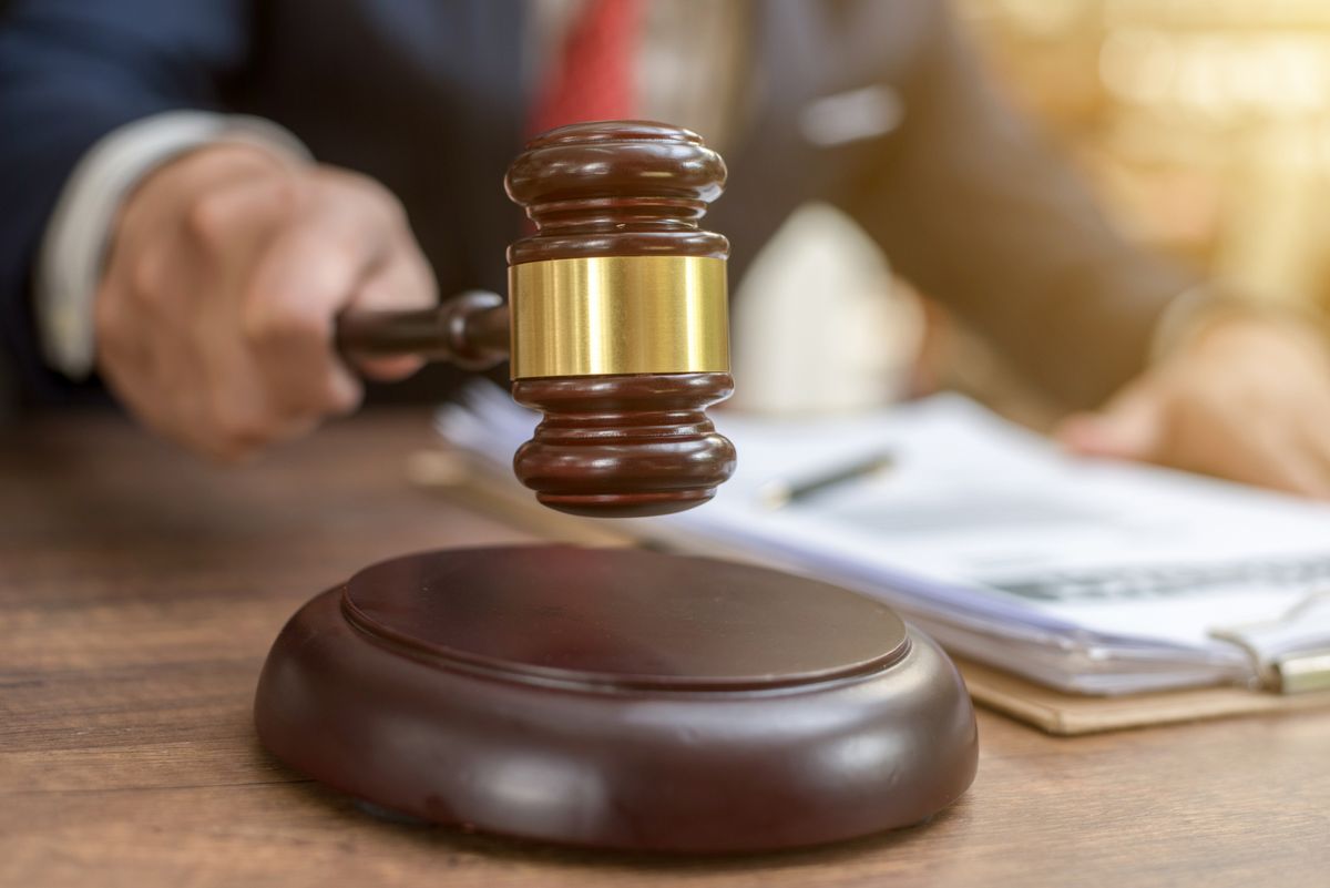 Close up lawyer businessman working or reading lawbook in office workplace for consultant lawyer concept.