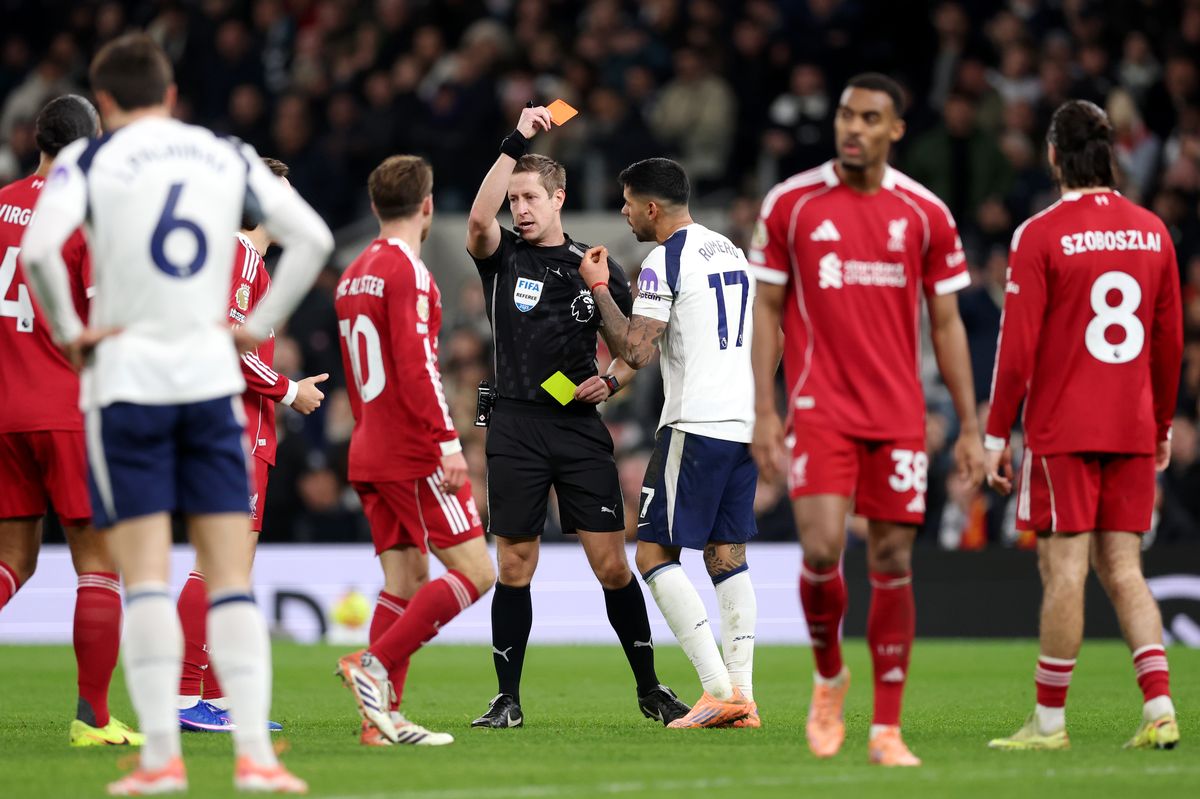Cristian Romero of Tottenham Hotspur receives a second yellow card from Referee John Brooks
