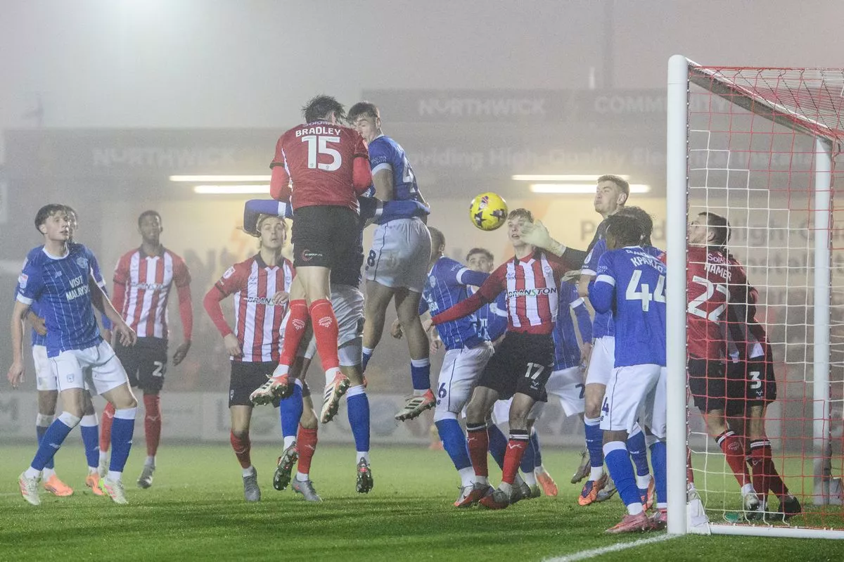 Sonny Bradley of Lincoln City scores his side's second goal