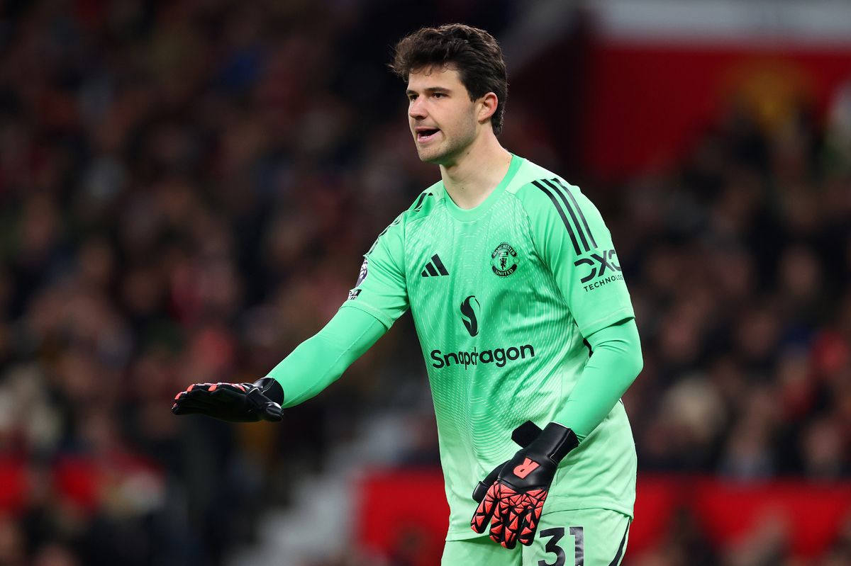 Senne Lammens of Manchester United gestures with his hands 