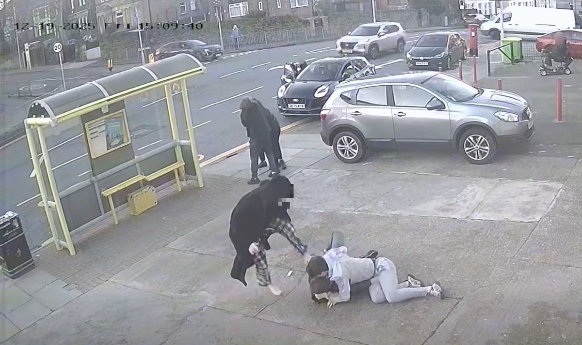 A barefoot youth in a dressing gown can be seen stamping on another youth who is lying on the floor