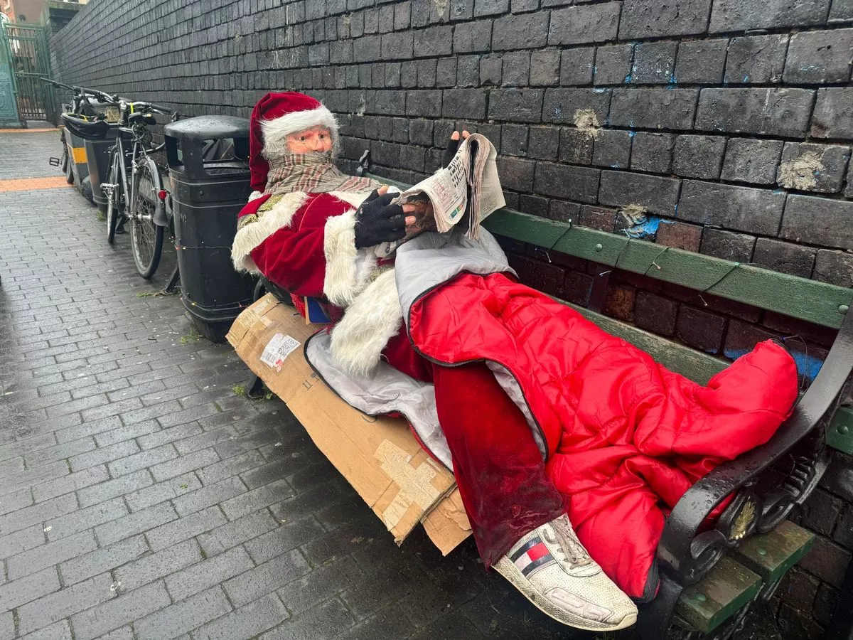 The life-size Santa tucked inside a sleeping bag