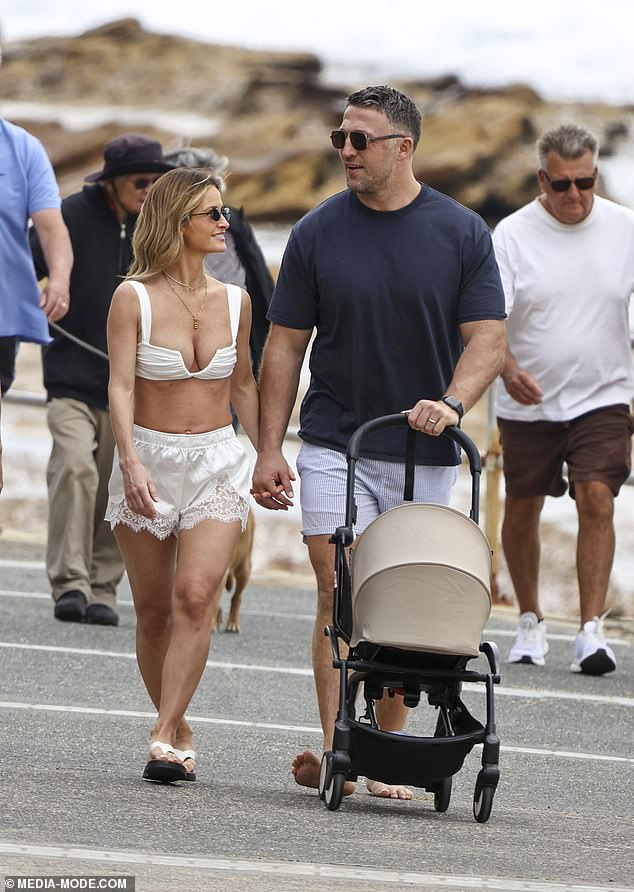 Later in the day, Sam slipped on a navy T-shirt and aviator sunglasses as he strolled down the boardwalk alongside Lucy, rounding out what appeared to be a perfect family day in the sun