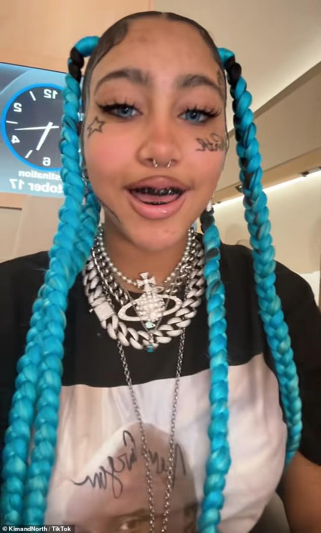 A couple months later in October, North took to her joint TikTok account she shares with her mom and debuted fake face tattoos as well as grillz