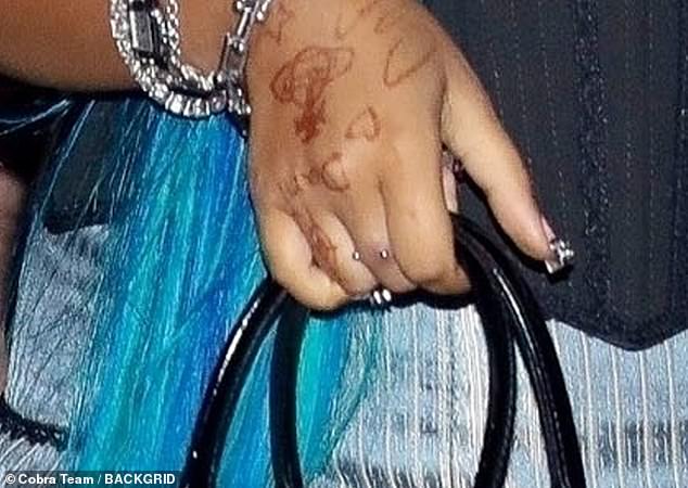 In August, she revealed what appeared to be a dermal piercing on her right hand during a trip to Italy with her mother - and consisted of two small silver balls below her knuckle on her middle finger (seen above)