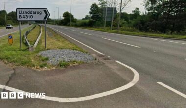 A sign on the A48 dual carriageway indicating the turn in for Llanddarog
