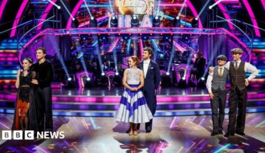 Karen Carney and Carlos Gu with their trophy after winning the 2025 series of Strictly Come Dancing.