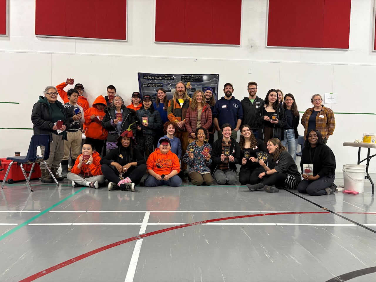 dozens of people stand and kneel together for a group photo