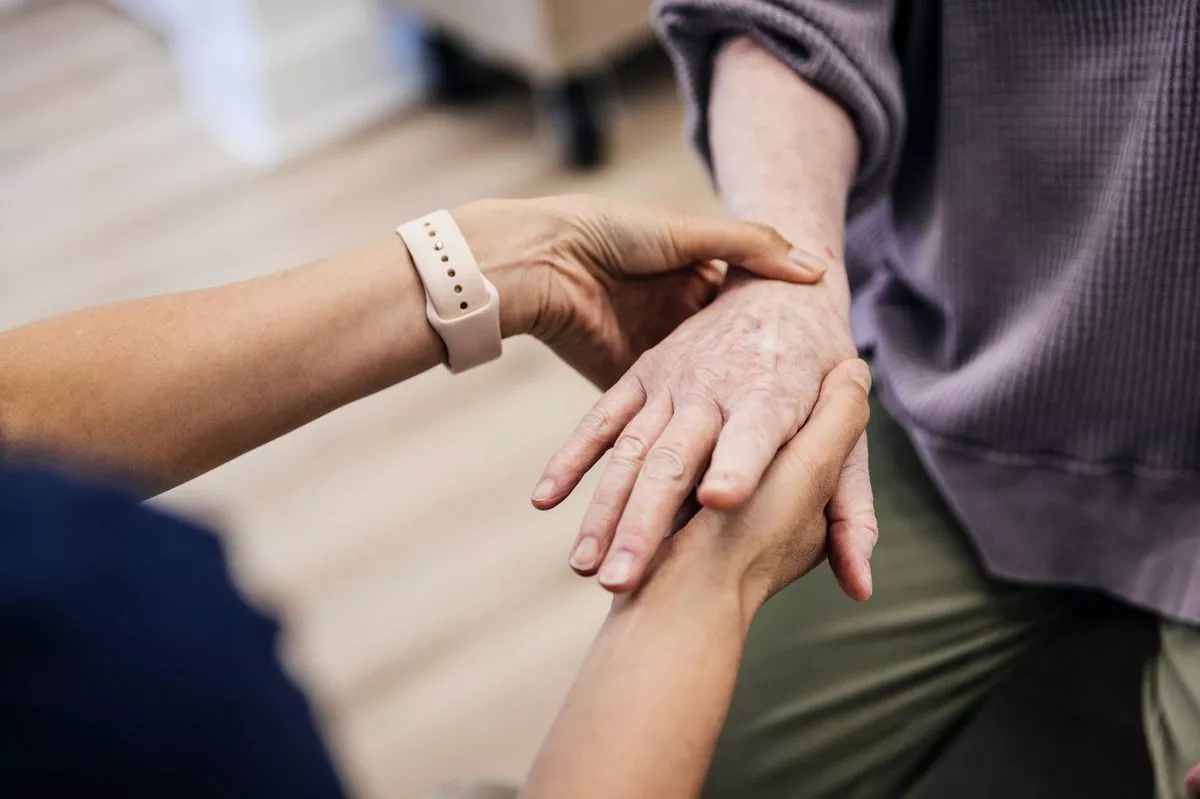 Close up of doctor examining senior woman's hand