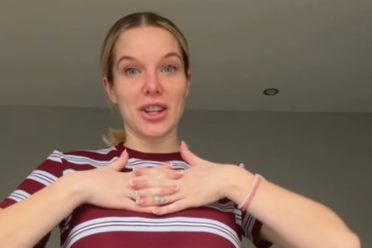 Helen Flanagan wearing a striped top and placing her hands on her chest