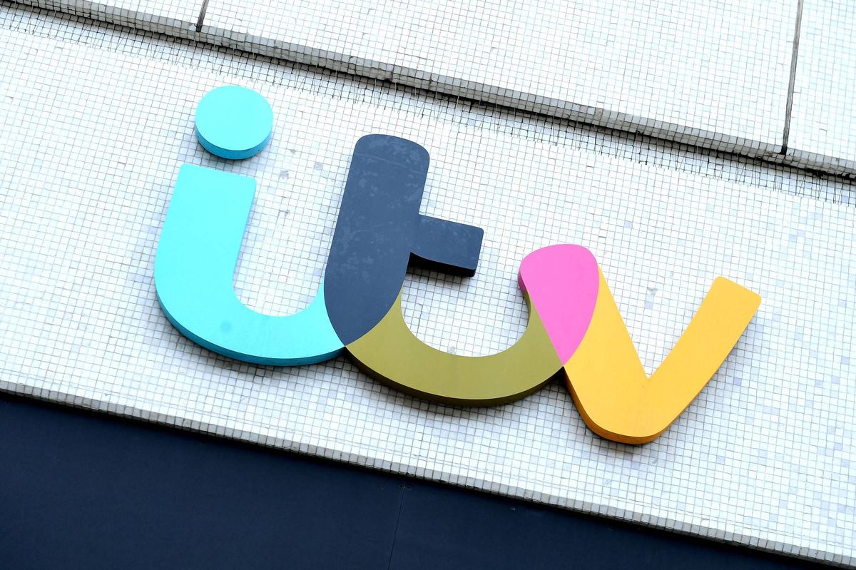 The "ITV" logo is affixed to a building exterior, composed of various colorful segments arranged in a playful, three-dimensional fashion.