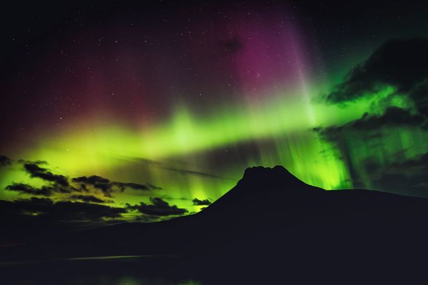 The Aurora Borealis over Stac Pollaidh, in the Highlands of Scotland.