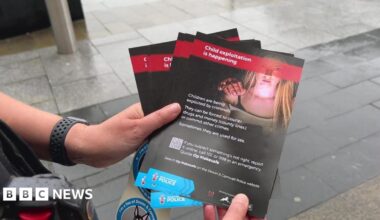 A pair of hands holding a child exploitation leaflet.