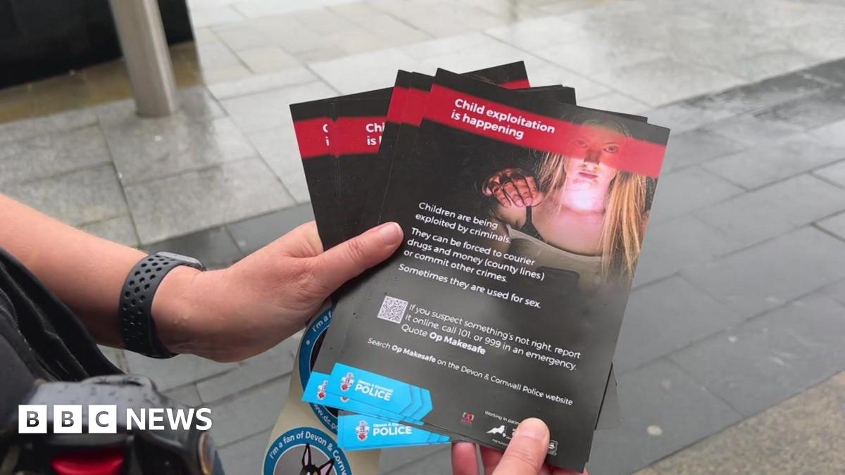 A pair of hands holding a child exploitation leaflet.