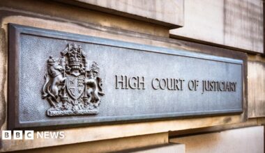 Close up of bronze sign saying High Court of Justiciary