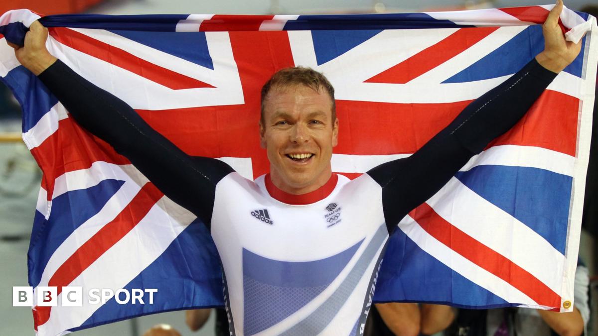 Sir Chris Hoy holding up two Olympic gold medals